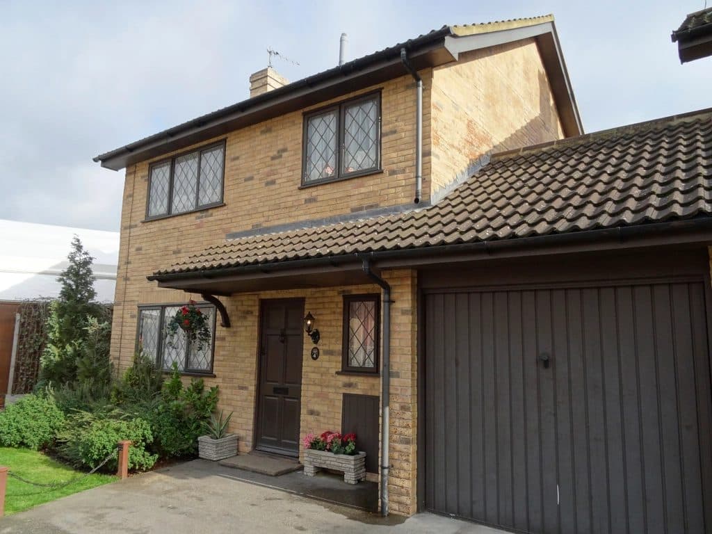 Two-storey brick house with side extension and garage